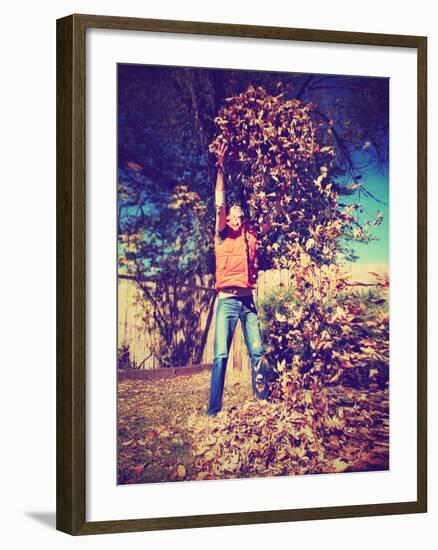 A Young Man Throwing Leaves in the Air-graphicphoto-Framed Photographic Print