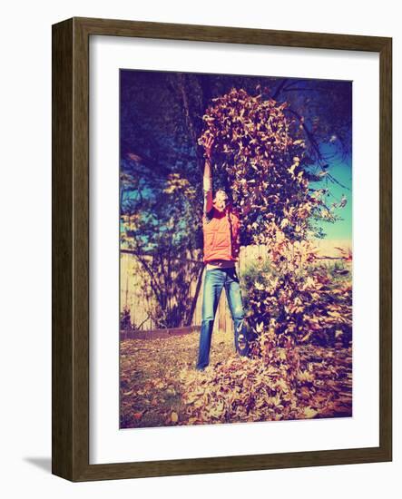 A Young Man Throwing Leaves in the Air-graphicphoto-Framed Photographic Print