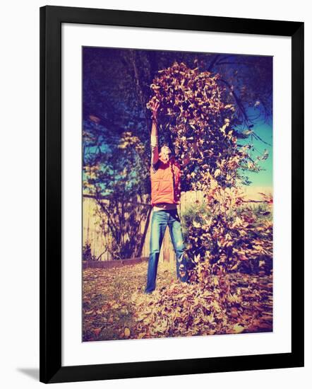 A Young Man Throwing Leaves in the Air-graphicphoto-Framed Photographic Print