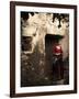 A Young Spanish Woman Wearing Traditional Flamenco Dress Standing in a Doorway to an Old Building-Steven Boone-Framed Photographic Print