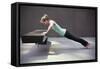 A Young Woman Does a Pushup on a Park Bench in San Francisco, California in Workout Apparel-Carlo Acenas-Framed Stretched Canvas