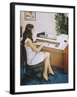 A Young Woman Office Worker Using What Now Looks Like a Rather Cumbersome Computer-null-Framed Photographic Print