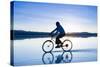 A Young Woman Rides Her Mountain Bike on the Flooded Salt Pan of the Salar De Uyuni in Sw Bolivia-Sergio Ballivian-Stretched Canvas