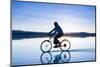 A Young Woman Rides Her Mountain Bike on the Flooded Salt Pan of the Salar De Uyuni in Sw Bolivia-Sergio Ballivian-Mounted Photographic Print