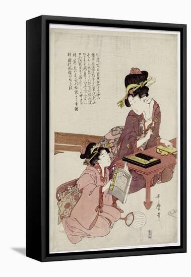 A Young Woman Seated at a Desk, Writing, a Girl with a Book Looks On-Kitagawa Utamaro-Framed Stretched Canvas