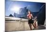 A Young Woman Stretches at the Walt Disney Concert Hall in Downtown Los Angeles, California-Carlo Acenas-Mounted Photographic Print