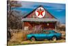 Abandoned blue Camaro Chevrolete in front of deserted Texaco Station, remote part of Nebraska-null-Stretched Canvas