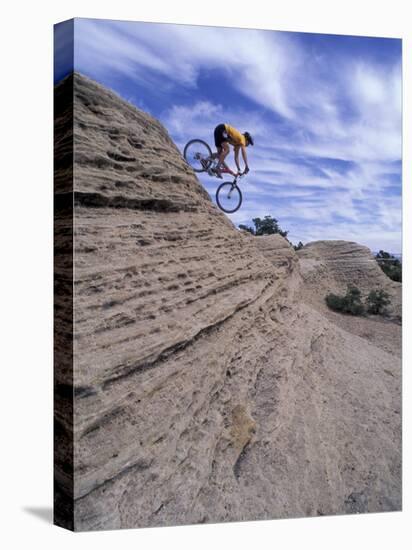 Active Male Rides Slickrock Ridge, Utah, USA-Howie Garber-Stretched Canvas