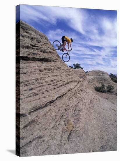 Active Male Rides Slickrock Ridge, Utah, USA-Howie Garber-Stretched Canvas