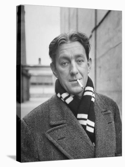 Actor Alec Guinness Dangling Cigarette from His Lips, on Movie Lot-Alfred Eisenstaedt-Stretched Canvas