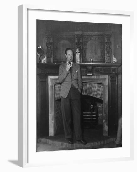 Actor Leslie Howard Smoking Pipe as He Stands by His Fireplace, at Home in Dorking, England-null-Framed Premium Photographic Print