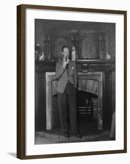 Actor Leslie Howard Smoking Pipe as He Stands by His Fireplace, at Home in Dorking, England-null-Framed Premium Photographic Print