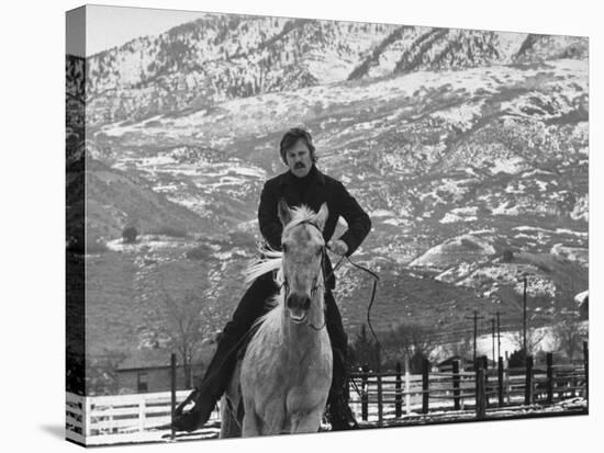 Actor Robert Redford Exercising One of His Eight Saddle Horses on His Remote Mountain Ranch-John Dominis-Stretched Canvas