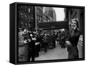 Actress Grace Kelly in Casual Pose with Armful of Roses Standing on Sidewalk During Shopping Trip-Lisa Larsen-Framed Stretched Canvas