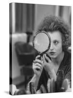 Actress Hanna Schygulla Looking in Hand Mirror While Applying Makeup-Alfred Eisenstaedt-Stretched Canvas