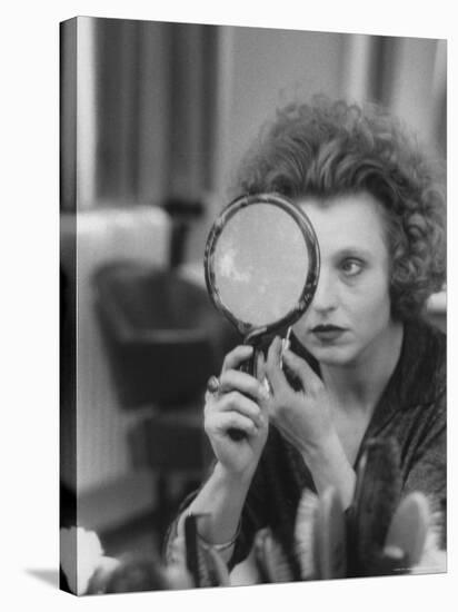 Actress Hanna Schygulla Looking in Hand Mirror While Applying Makeup-Alfred Eisenstaedt-Stretched Canvas