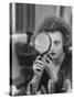 Actress Hanna Schygulla Looking in Hand Mirror While Applying Makeup-Alfred Eisenstaedt-Stretched Canvas