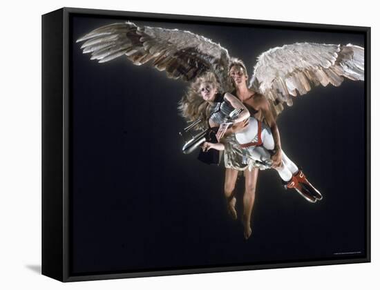 Actress Jane Fonda Being Carried by Guardian Angel in a Scene from Roger Vadim's Film "Barbarella"-Carlo Bavagnoli-Framed Stretched Canvas