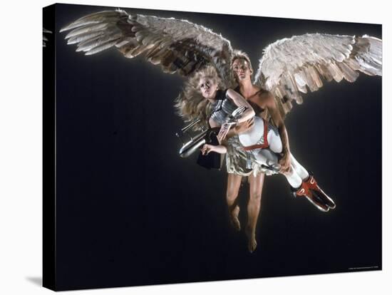 Actress Jane Fonda Being Carried by Guardian Angel in a Scene from Roger Vadim's Film "Barbarella"-Carlo Bavagnoli-Stretched Canvas