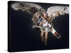 Actress Jane Fonda Being Carried by Guardian Angel in a Scene from Roger Vadim's Film "Barbarella"-Carlo Bavagnoli-Stretched Canvas