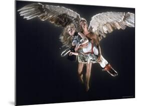 Actress Jane Fonda Being Carried by Guardian Angel in a Scene from Roger Vadim's Film "Barbarella"-Carlo Bavagnoli-Mounted Premium Photographic Print