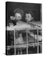 Actress Joan Fontaine with Actress Sister Olivia de Havilland Looking Out of Open Window at Home-Bob Landry-Stretched Canvas