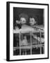 Actress Joan Fontaine with Actress Sister Olivia de Havilland Looking Out of Open Window at Home-Bob Landry-Framed Premium Photographic Print