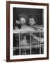 Actress Joan Fontaine with Actress Sister Olivia de Havilland Looking Out of Open Window at Home-Bob Landry-Framed Premium Photographic Print