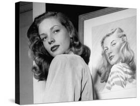 Actress Lauren Bacall Posing in Front of Portrait Drawing of Herself in Suite at the Gotham Hotel-Nina Leen-Stretched Canvas