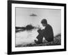 Actress Mia Farrow Pensively Sitting on Rocky Shore of Lake Geneva as Passenger Boat Passes By-Bill Eppridge-Framed Premium Photographic Print