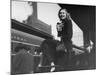 Actress Patricia Neal Sitting on Her Luggage on the Platform of a Train Station During a Stopover-Ed Clark-Mounted Premium Photographic Print