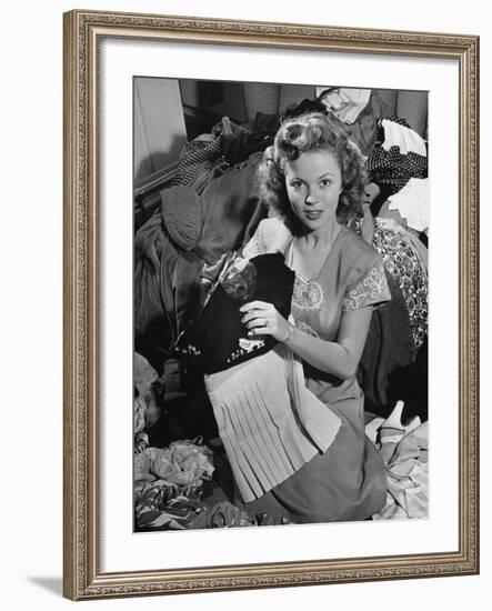 Actress Shirley Temple, Gathering Her Unwanted Clothes Together to Donate to a Clothing Drive-Martha Holmes-Framed Premium Photographic Print