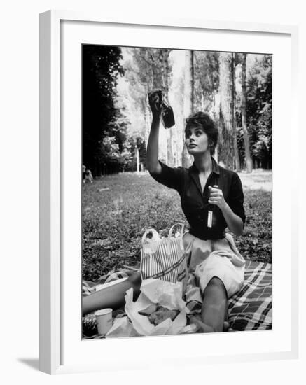 Actress Sophia Loren Examining Contents of Bottle During Location Filming of "Madame Sans Gene"-Alfred Eisenstaedt-Framed Premium Photographic Print