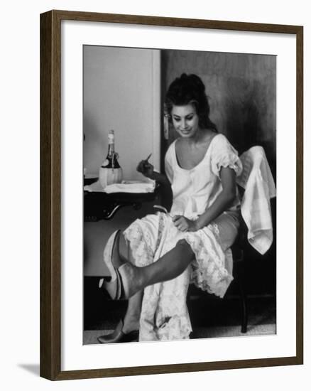 Actress Sophia Loren Looking at Her Foot While Eating During Filming of "Madame Sans Gene"-Alfred Eisenstaedt-Framed Premium Photographic Print