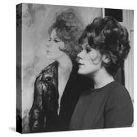 Actress, Tammy Grimes, Posing in Front of Portrait by Rene Bouche-Dmitri Kessel-Stretched Canvas