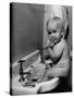 Adorable Baby Brushing Teeth While Sitting in Sink-null-Stretched Canvas