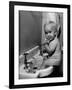 Adorable Baby Brushing Teeth While Sitting in Sink-null-Framed Photographic Print