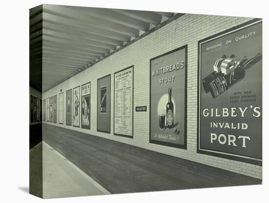 Advertisements for Beer and Port, Holborn Underground Tram Station, London, 1931-null-Stretched Canvas