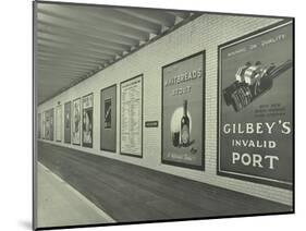 Advertisements for Beer and Port, Holborn Underground Tram Station, London, 1931-null-Mounted Photographic Print