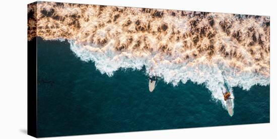 Aerial drone photo of surfers riding Pacific Ocean waves in San Diego, California at Sunset Cliffs-David Chang-Stretched Canvas
