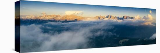 Aerial panoramic view of Brenta Dolomites emerging from clouds, Madonna di Campiglio-Roberto Moiola-Stretched Canvas
