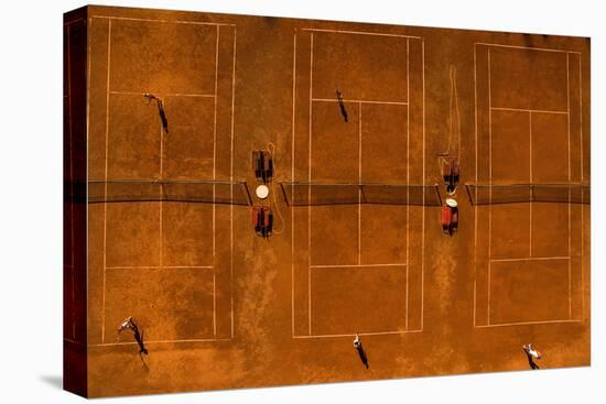 Aerial Shot of a Tennis Courts with Players in Warm Evening Sunlight-l i g h t p o e t-Stretched Canvas