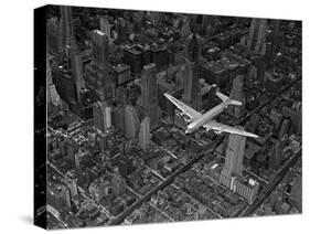 Aerial View of a DC-4 Passenger Plane Flying over Midtown Manhattan-Margaret Bourke-White-Stretched Canvas