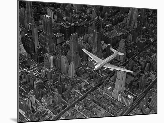 Aerial View of a DC-4 Passenger Plane Flying over Midtown Manhattan-Margaret Bourke-White-Mounted Photographic Print