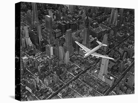 Aerial View of a Dc-4 Passenger Plane in Flight over Manhattan-Margaret Bourke-White-Stretched Canvas