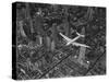 Aerial View of a Dc-4 Passenger Plane in Flight over Manhattan-Margaret Bourke-White-Stretched Canvas