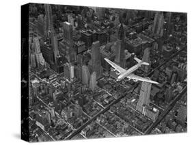 Aerial View of a Dc-4 Passenger Plane in Flight over Manhattan-Margaret Bourke-White-Stretched Canvas