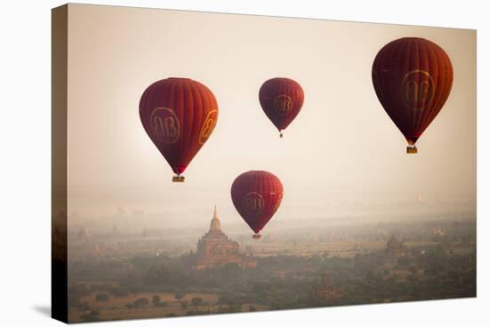 Aerial View of Balloons over Ancient Temples of Bagan at Sunrise in Myanmar-Harry Marx-Stretched Canvas