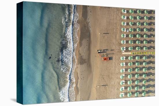 Aerial view of beach umbrellas and sunbeds in tidy rows during summer, Vieste-Roberto Moiola-Stretched Canvas