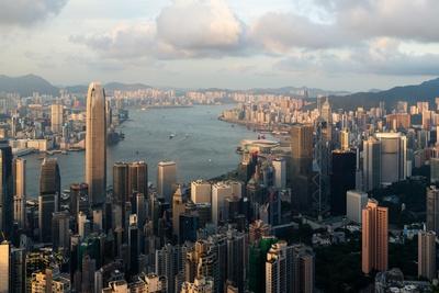 Aerial view of Hong Kong skyline and Victoria Harbor with blue sky in ...